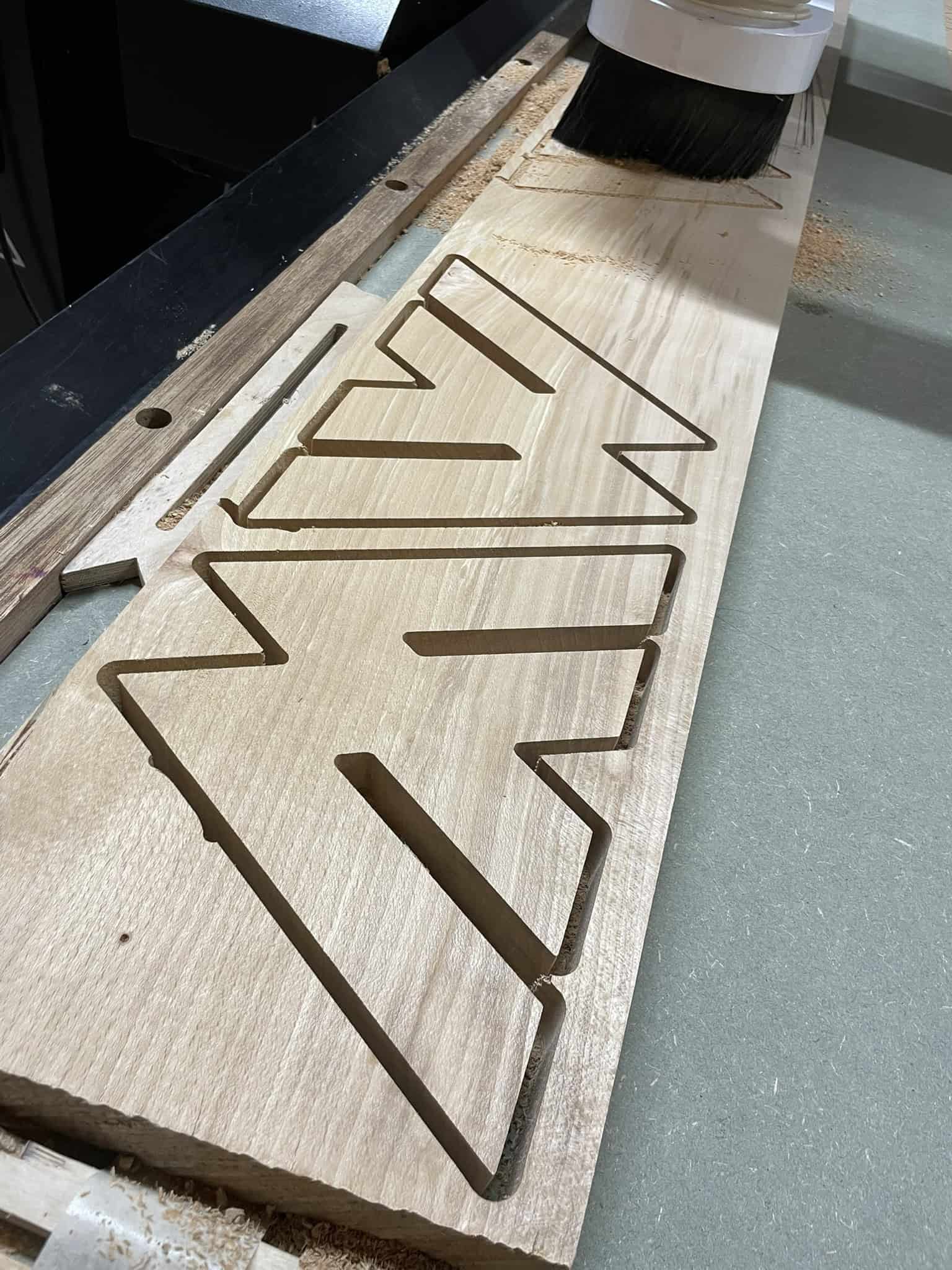 Image showing the letter M being carved out using a 6mm end mill which could also be mistaken for a W